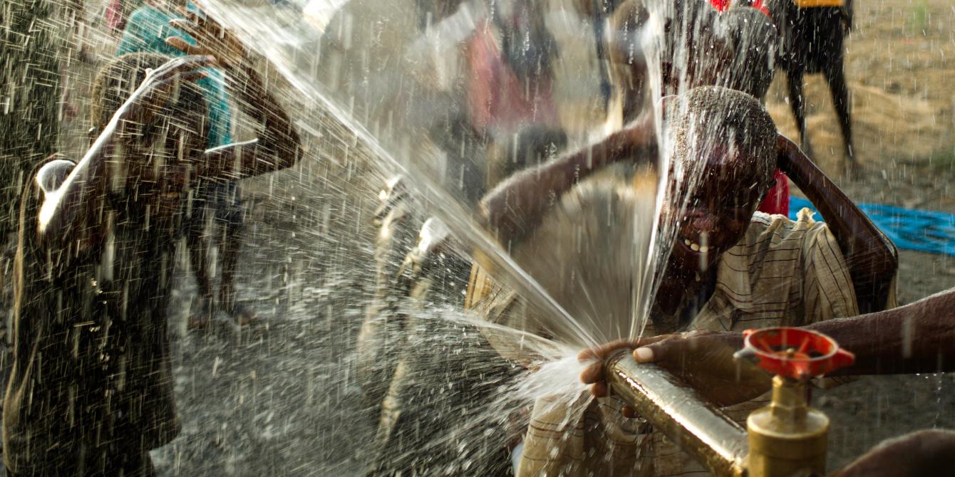 Who we are Children play in the borehole fresh water as it is sprayed from a pipe in the village of Nawoyatir in the Lapur district of Lokitaung in Turkana. Photo Credit Kieran Doherty/Oxfam